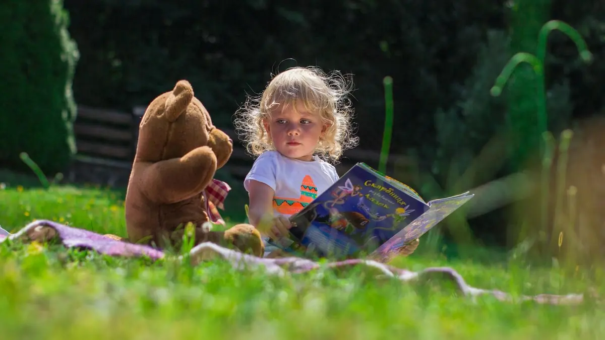 Girl Sitting Beside A Teddy Bear