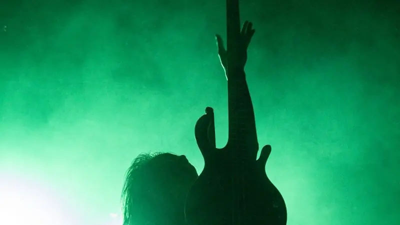 silhouette of people raising hands