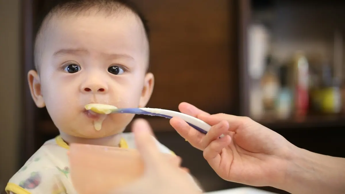 person feeding baby