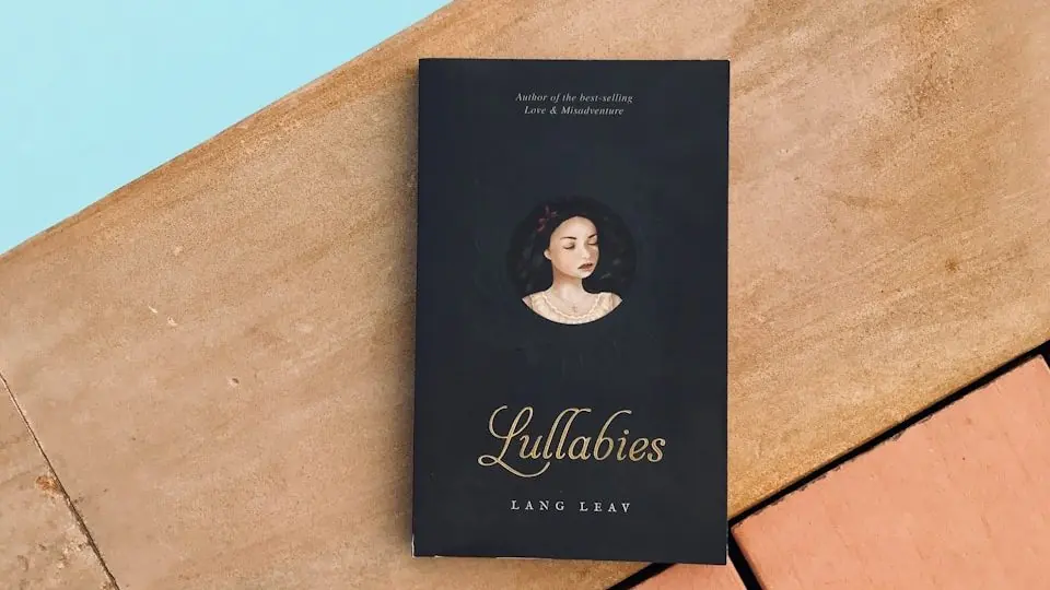 a book sitting on top of a wooden floor next to a pool