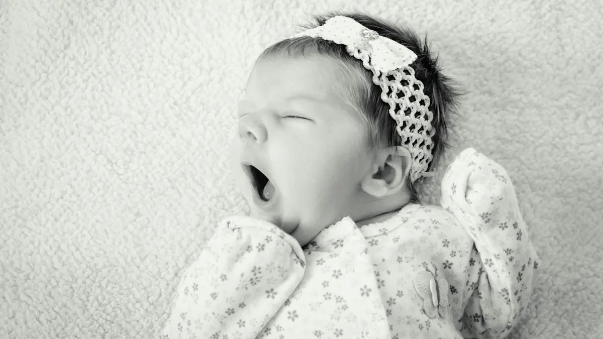 baby wearing sleeper suit