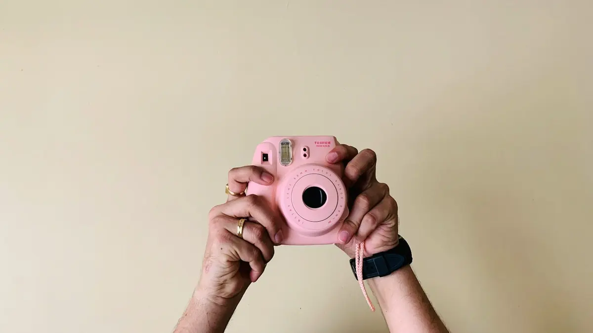 person holding pin camera