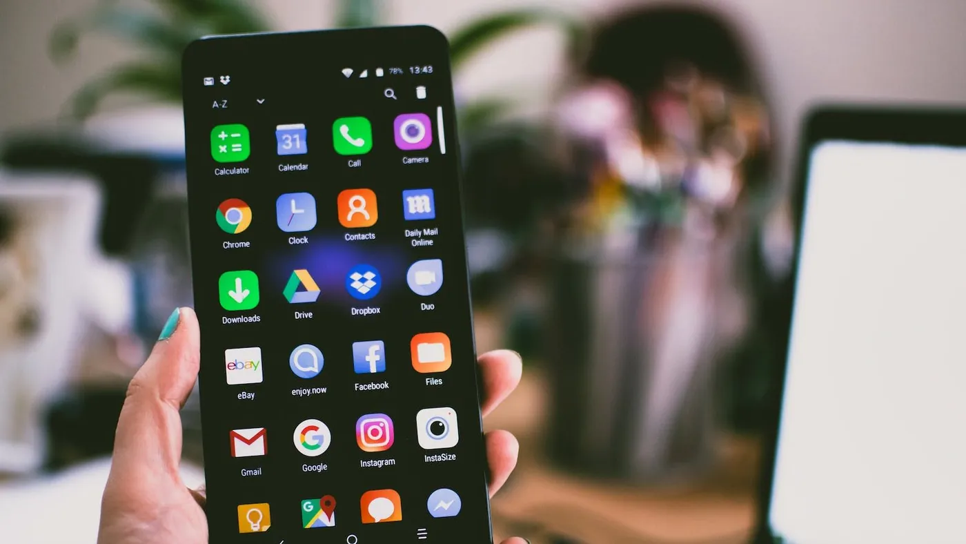 Selective Focus Photography of Person Holding Turned on Smartphone