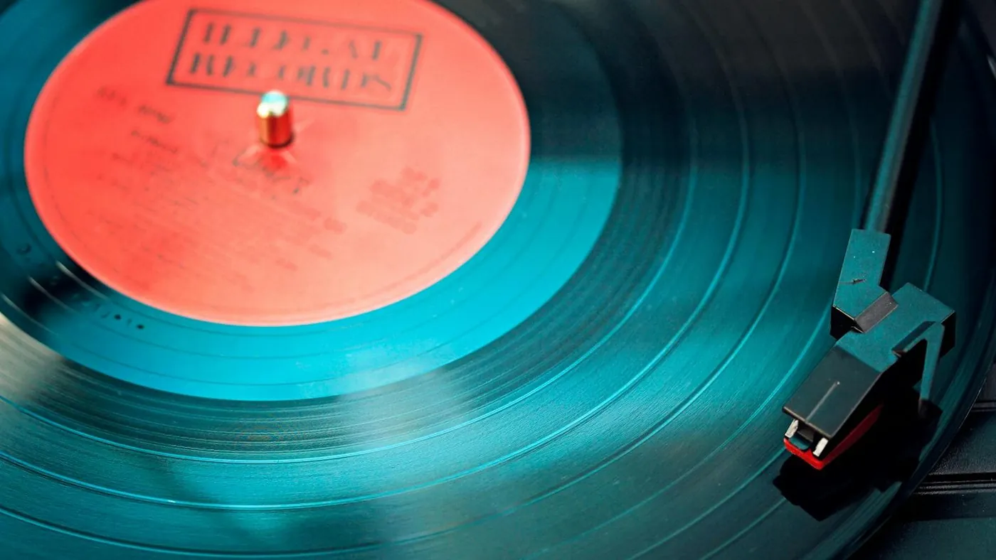 Blue Vinyl Record Playing on Turntable