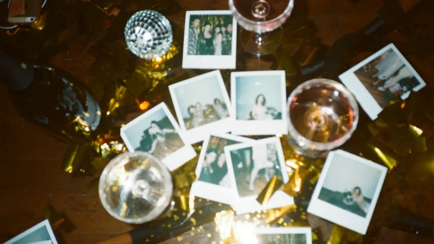 Wine Glasses And Pictures On Table