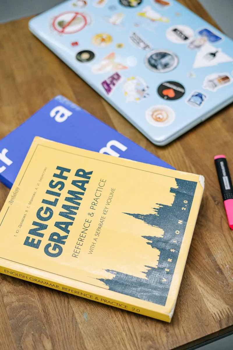 Laptop and Books on Brown Wooden Table
