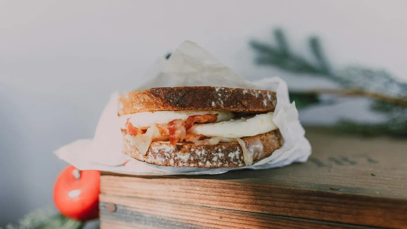 A Bacon and Egg Sandwich over a Wooden Box