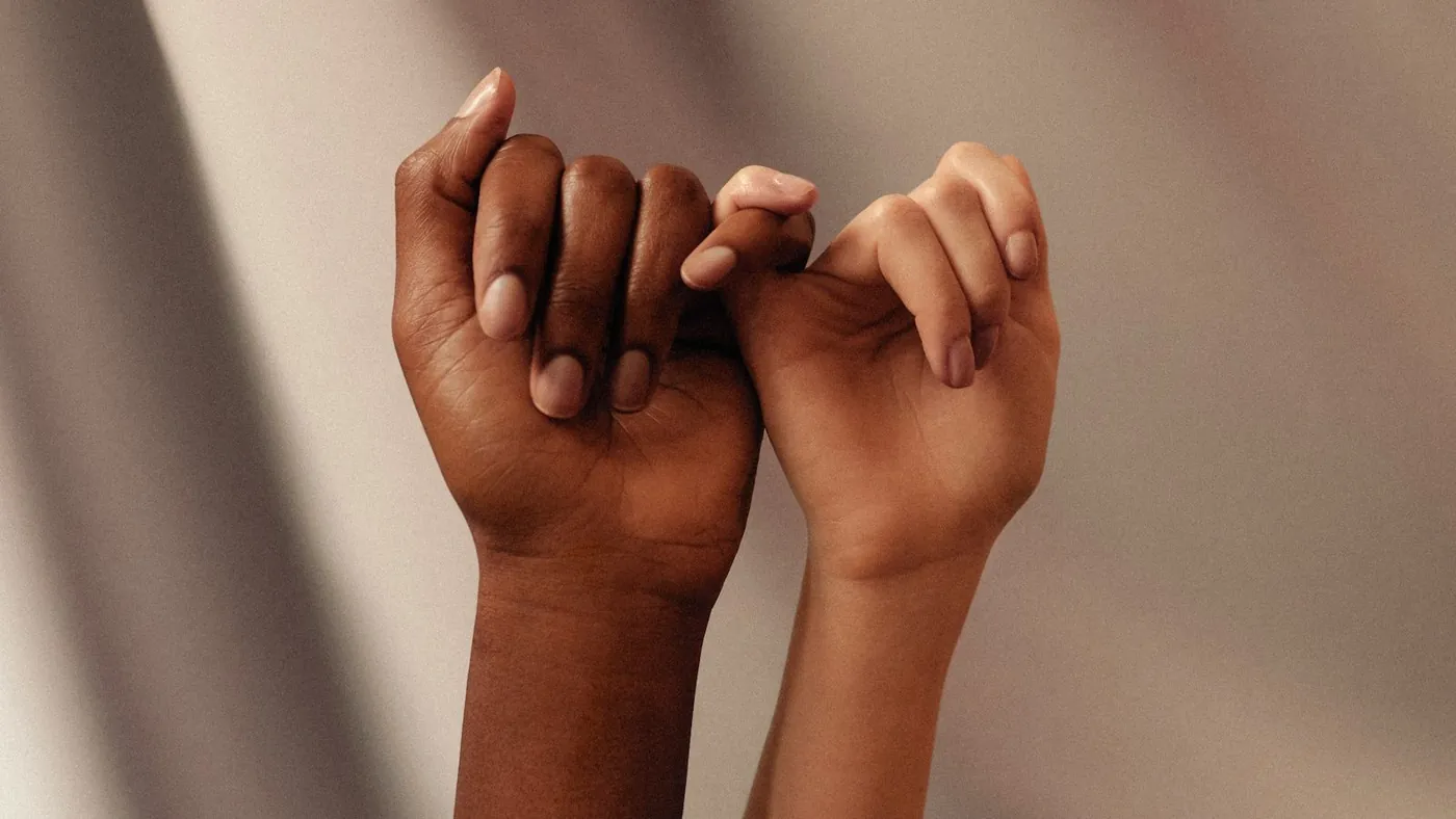 persons hand with white manicure
