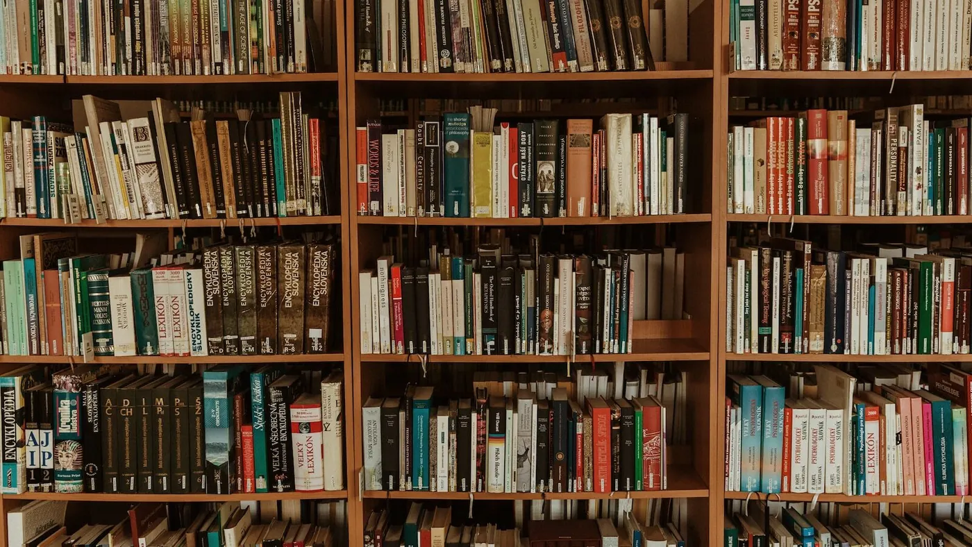 brown wooden book shelf with books