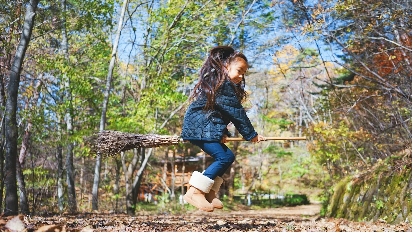 girl riding broom stick