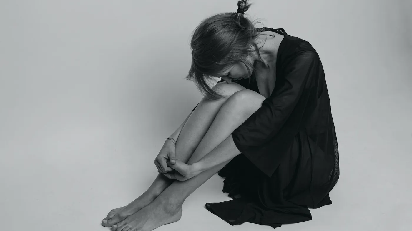 woman in black dress sitting on floor