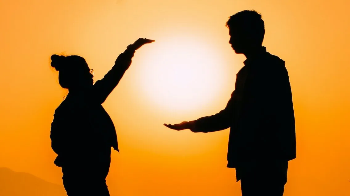 silhouette of man raising his hands