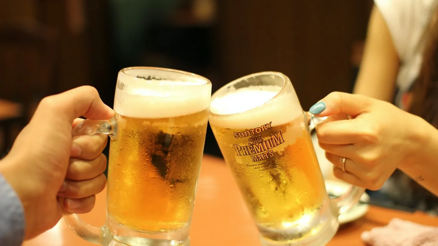two mugs of brown liquids