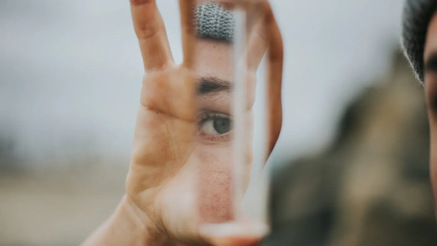 shallow focus of person holding mirror