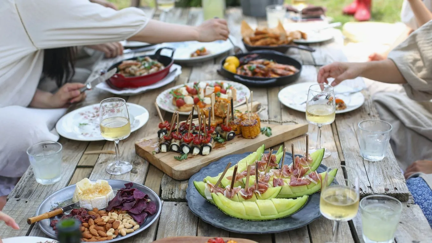 group of people eating on backyard