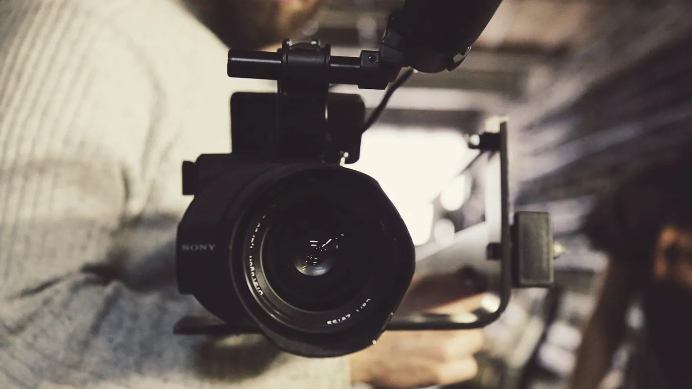 closeup photo of person carrying professional video recorder