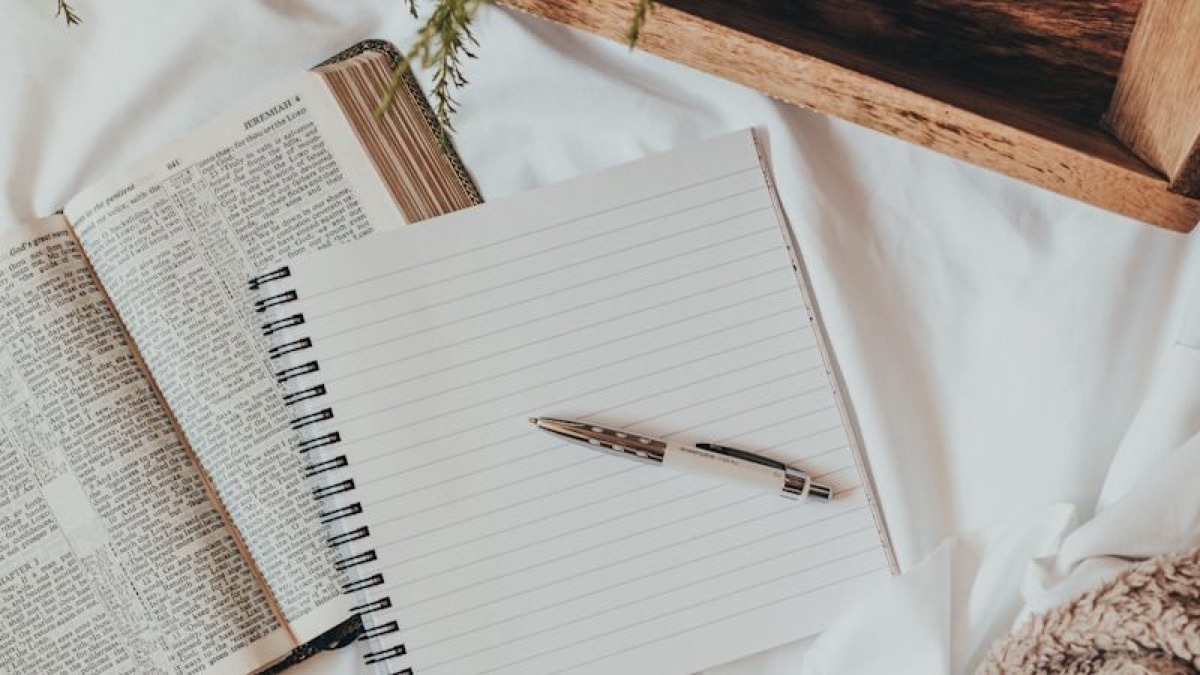 white notebook on white textile